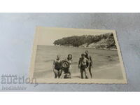 Photo Three men two women and a boy on the beach