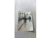 Foto Fată tânără cu o bicicletă de epocă pe stradă
