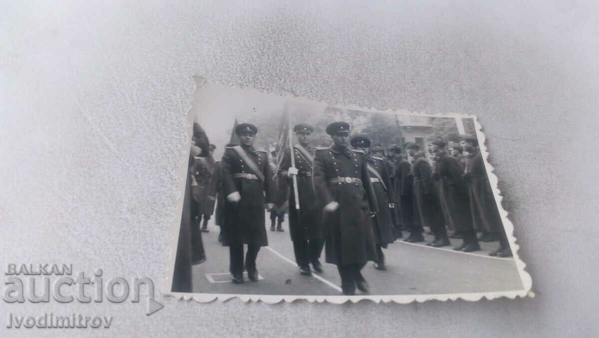 Photo Officers march in front of soldiers in formation