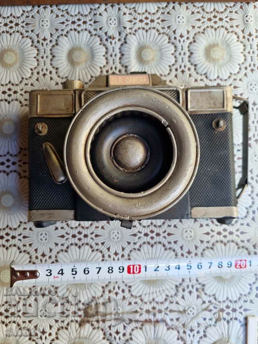 A large metal model of a camera