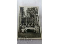Picture Men and women having a drink around a table
