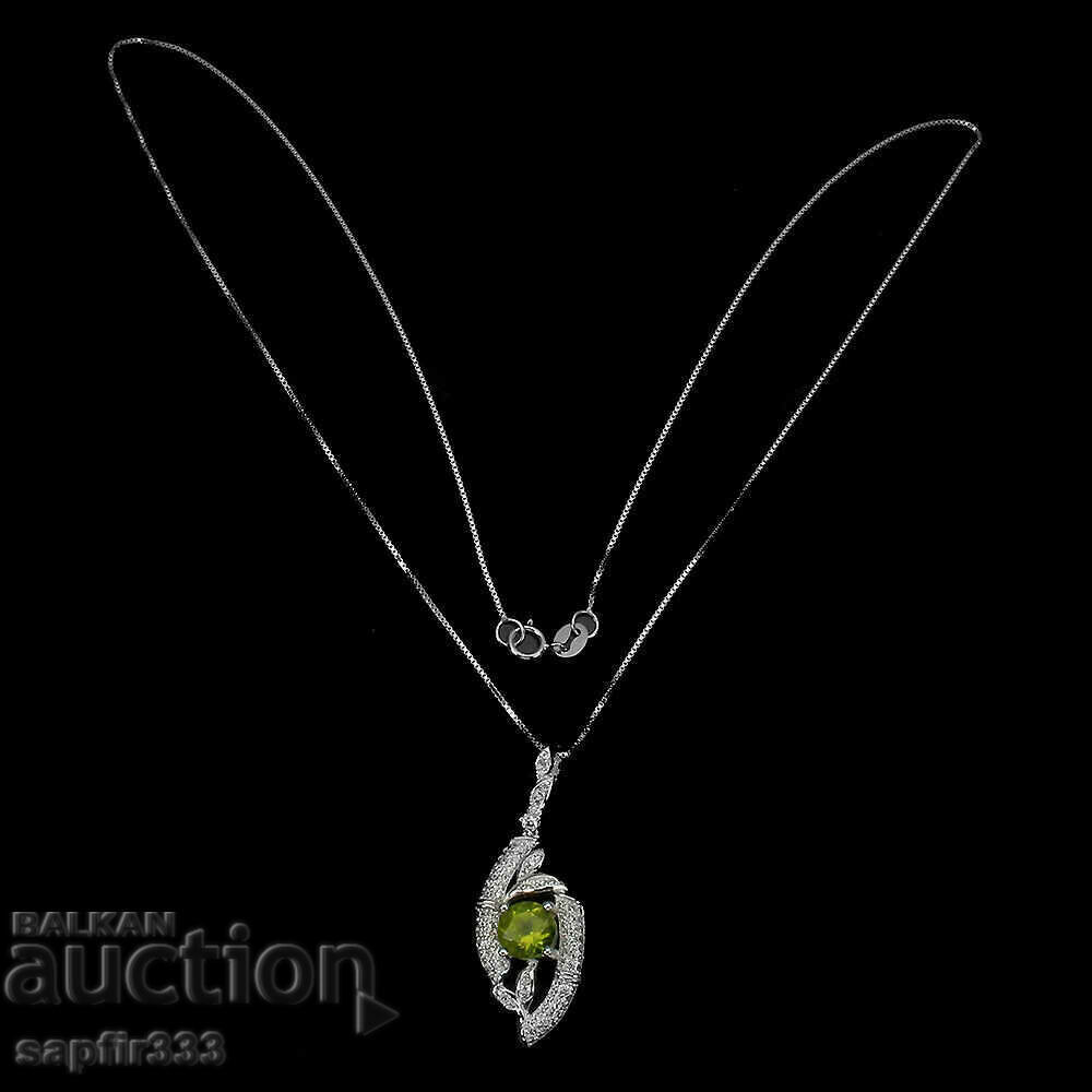 Auction FINE SILVER MEDALLION WITH NATURAL PERIDOT AND ZIRCONIA Auction FINE SILVER MEDALLION WITH NATURAL PERIDOT AND ZIRCONIA
