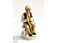 Figure of an old man seated on a bench
