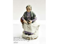 Figure of an old woman sitting on a bench