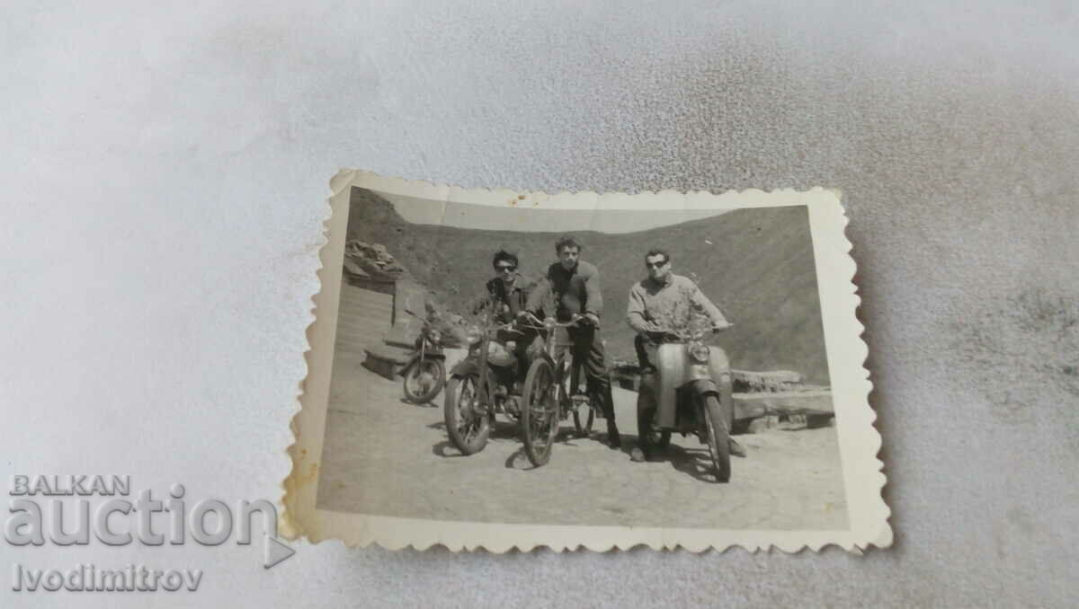 Photo Three young men on vintage motorbikes