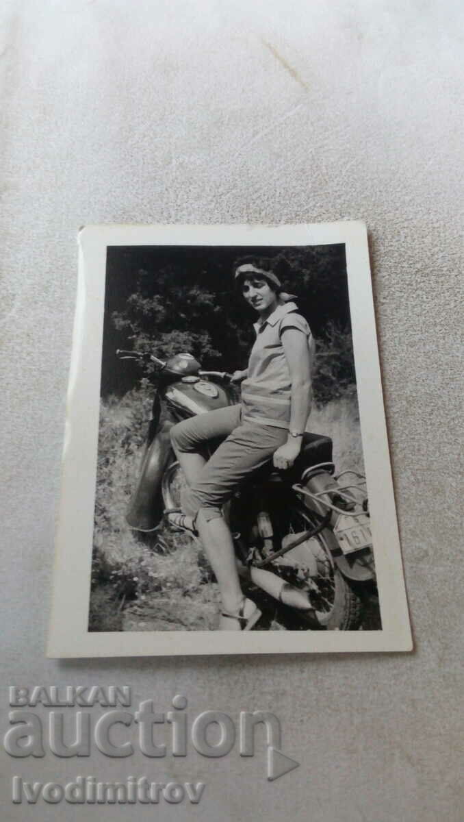 Fotografie Tânără cu o motocicletă de epocă