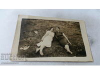 Photo Two women lying on the grass