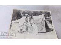 Photo A man and a negro dressed in sheets in front of a large tent