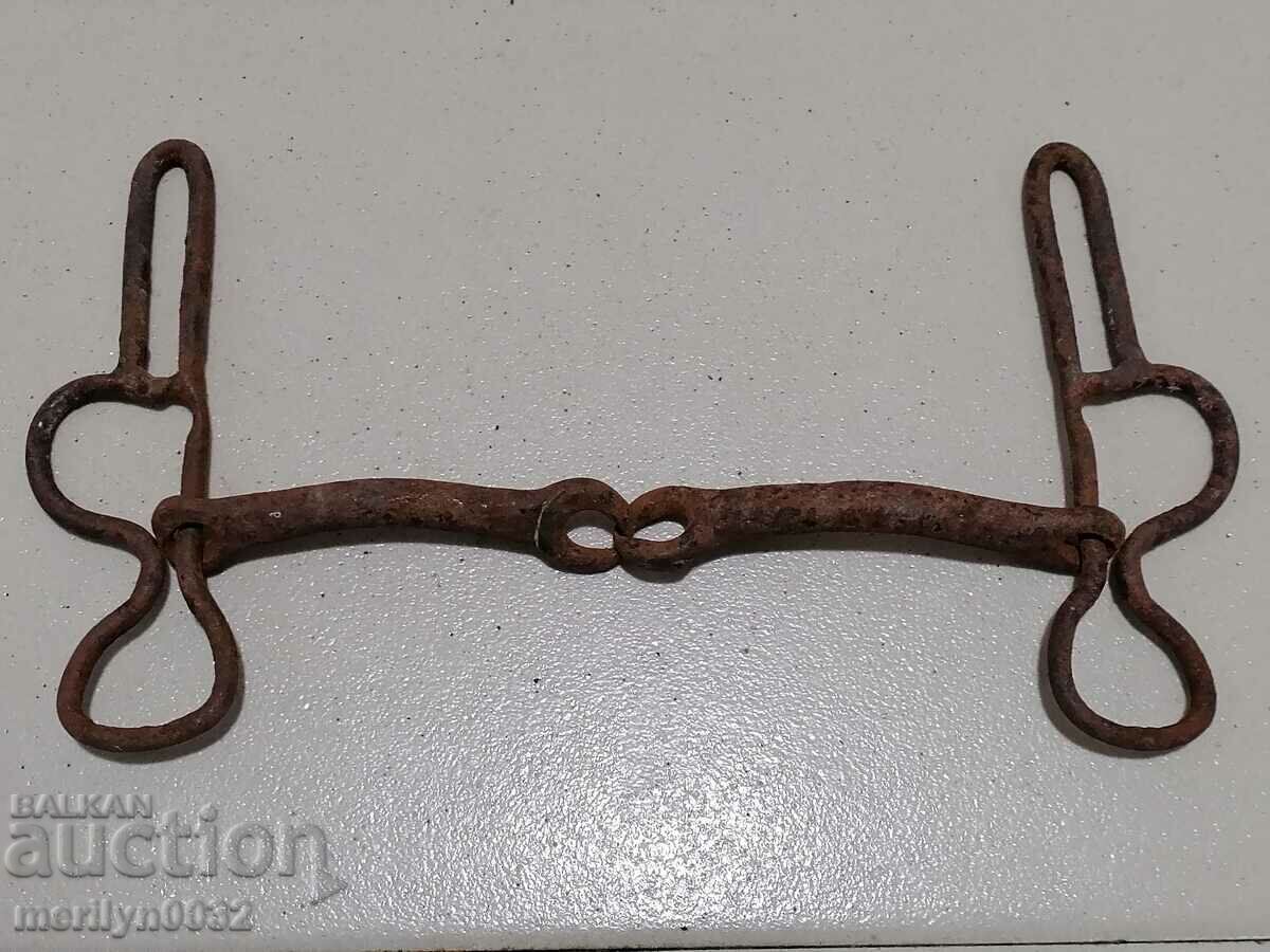 An old forged bridle reins wrought iron, a harness