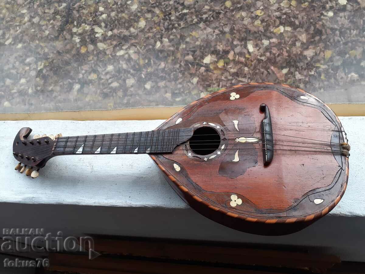 Old luxury mandolin with mother-of-pearl inlays