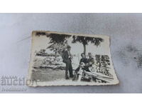 Photo Two men and a woman on a wooden bench