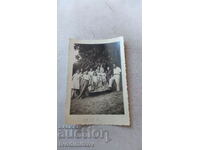 Photo Ruse A large company in front of a vintage car. Reg. No. Rs 19_8