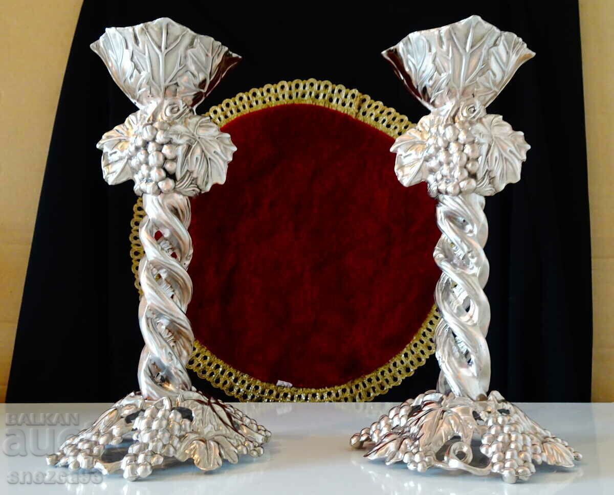Silver-plated candlesticks, vines, grapes. Silver-plated candlesticks, vines, grapes.