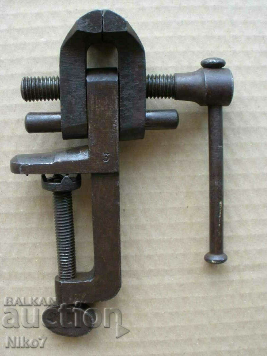 Old, marked, small vise.
