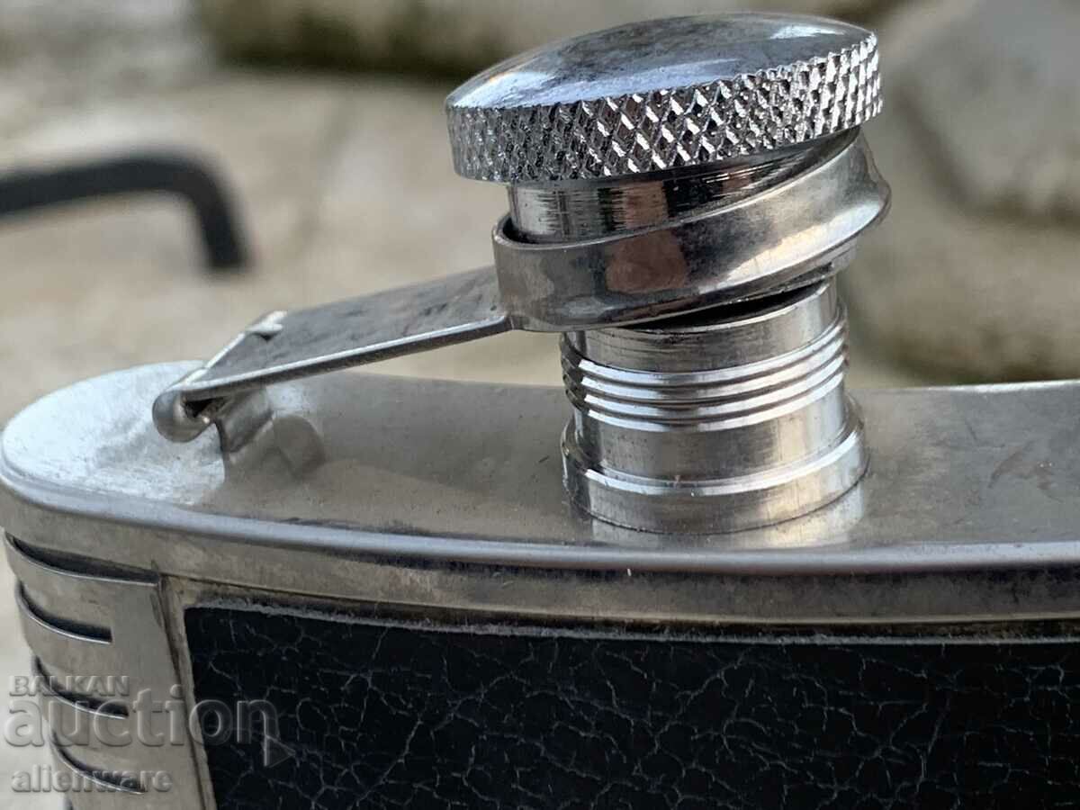 Auction Metal and leather alcohol bottle Auction Metal and leather alcohol bottle