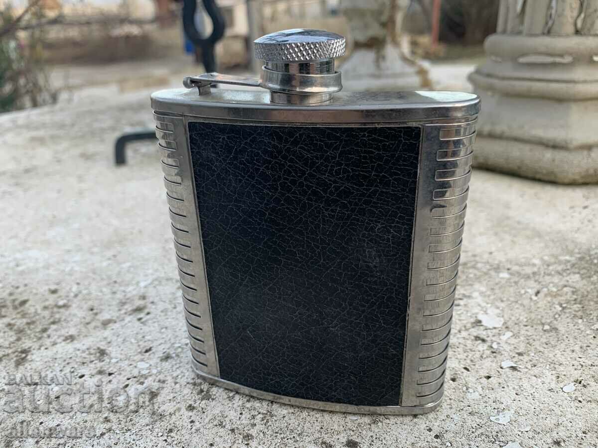 Metal and leather alcohol bottle