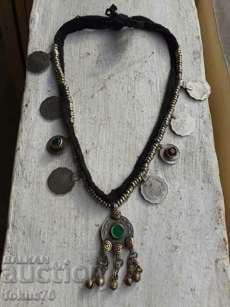 Old costume jewelry with coins and stones