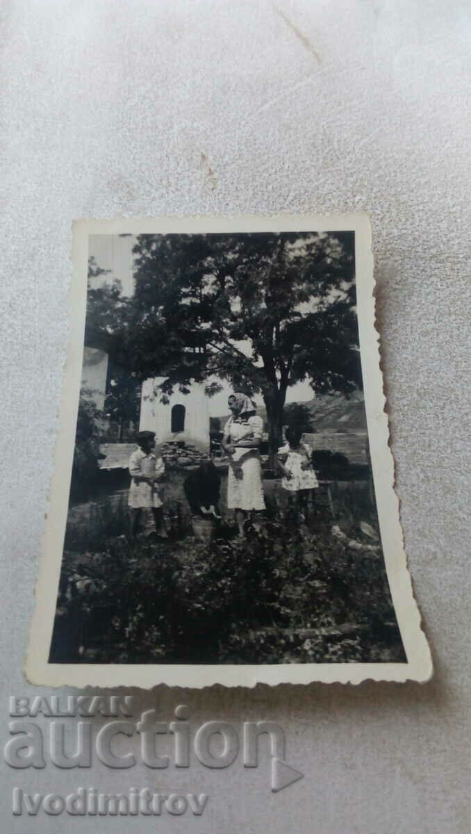 Φωτογραφία Γυναίκα και παιδιά στον κήπο