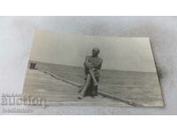 Ms. Obzor A man in a swimsuit and a swimming cap on a wooden pier