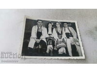 Photo Two young men and two women in folk costumes