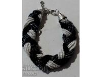 Braided bracelet with mini white and black pearls