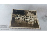 Снимка Млади момичета с ретро бански седнали на бент на река