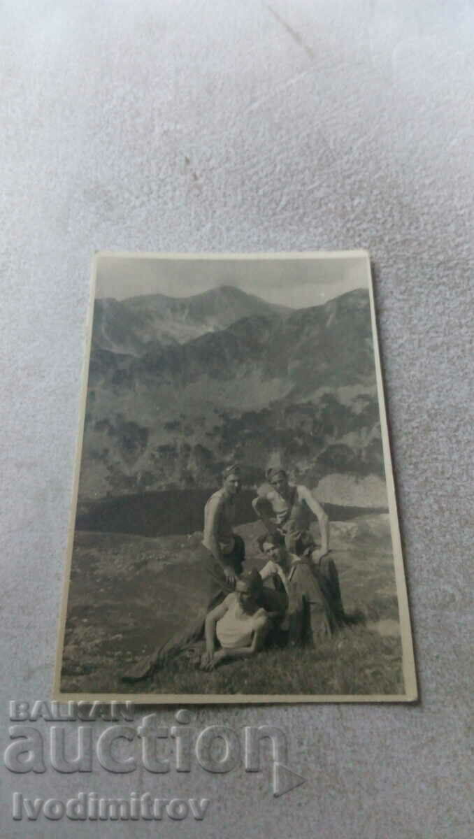 Photo Four soldiers in front of a mountain lake