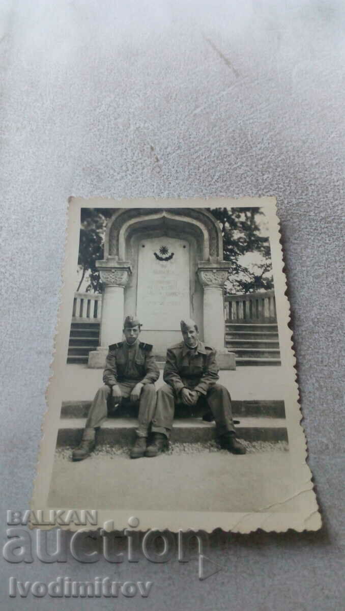 Photo Two sergeants on steps in front of a war memorial