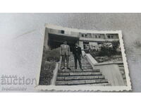 Photo Two young men on stairs in front of a station