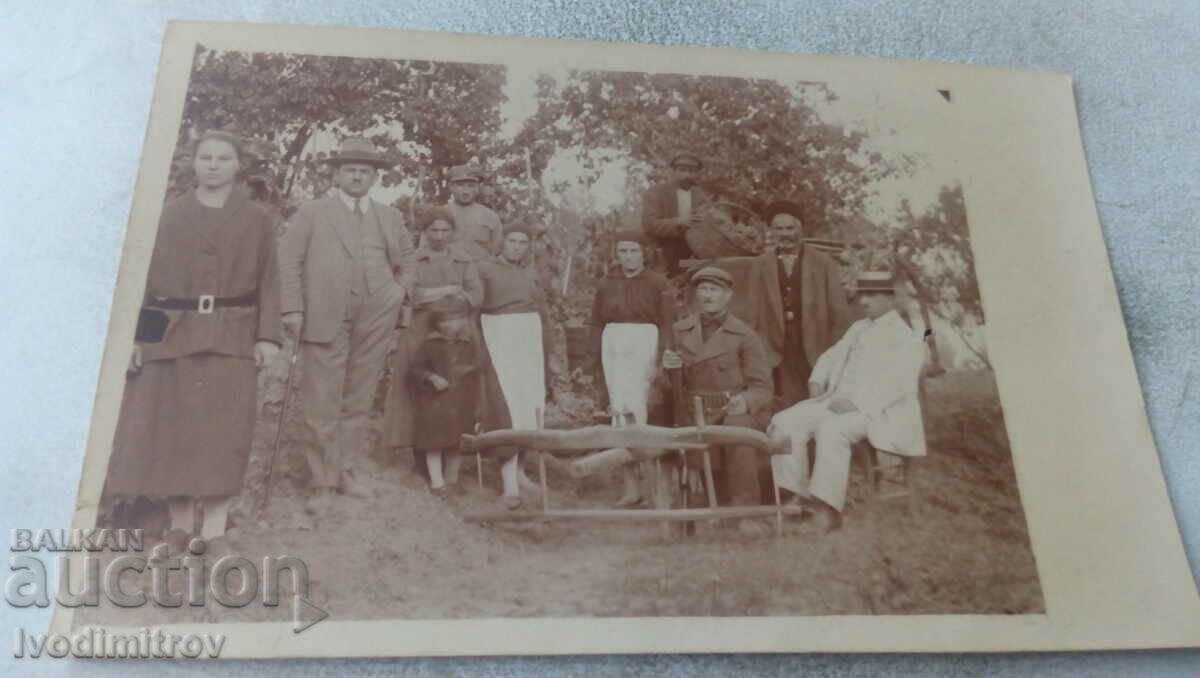 Picture Men and women next to a bullock cart