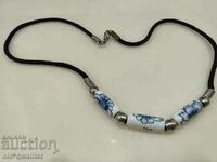 Old necklace with porcelain elements in blue/white