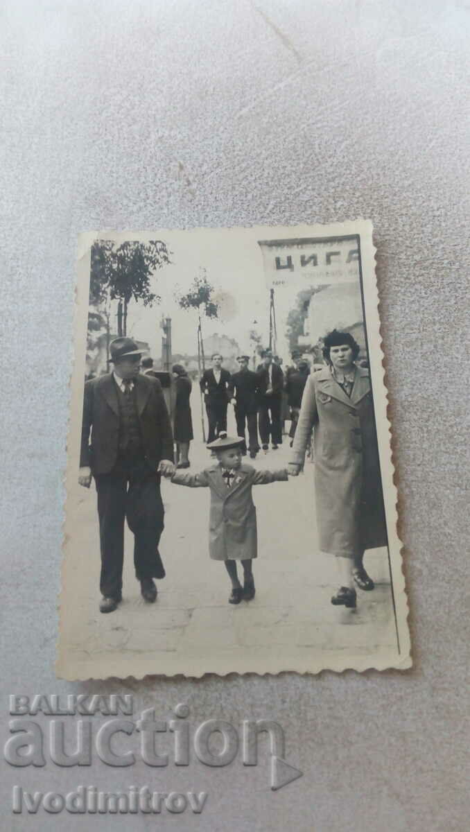 Photo A man, a woman and a little boy on a walk