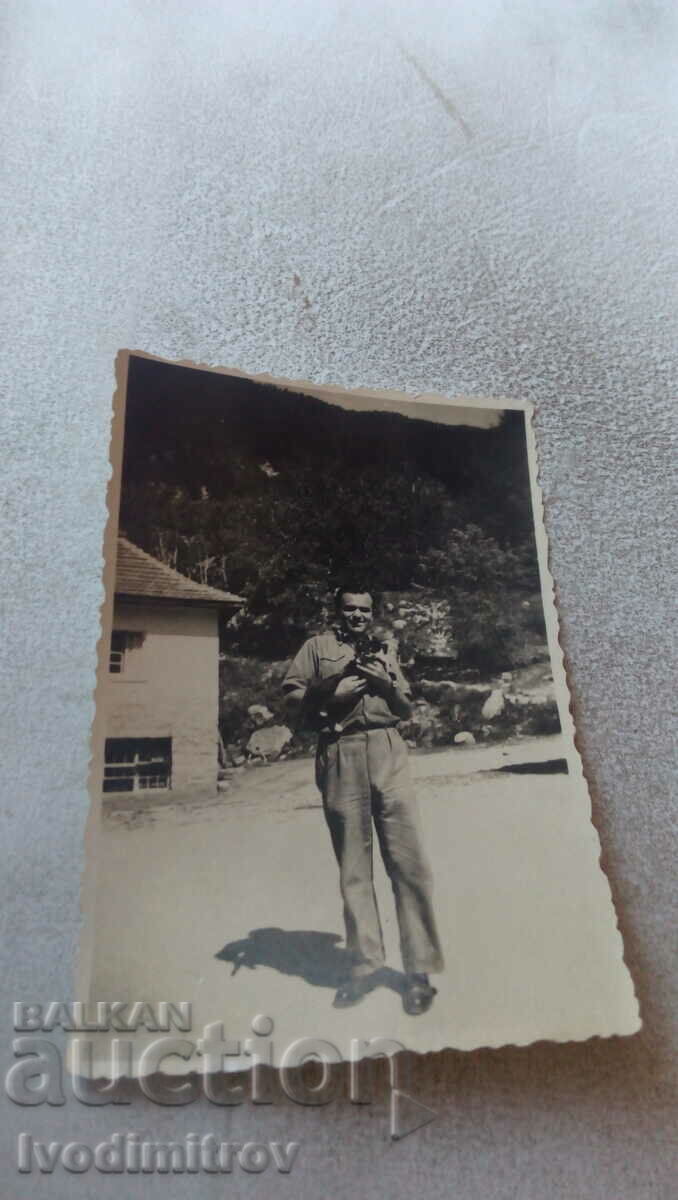 Photo A man with a small kitten in his hands
