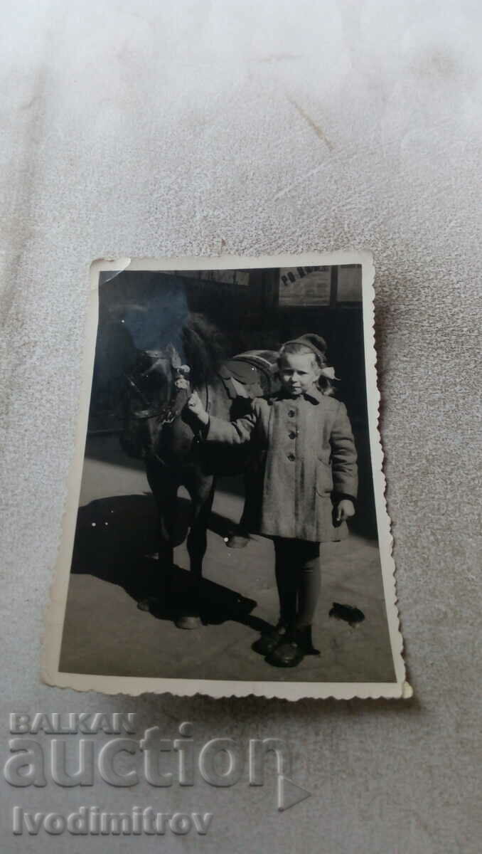 Photo Girl with a black pony