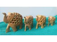 Hand-carved figures of 4 small elephants