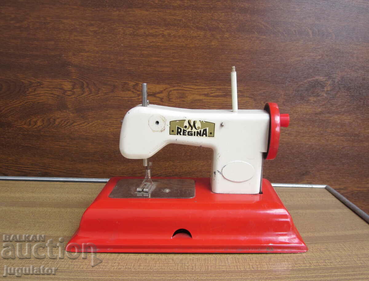 old mechanical metal sheet metal toy sewing machine