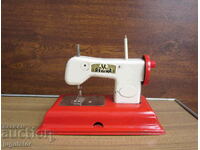 old mechanical metal sheet metal toy sewing machine