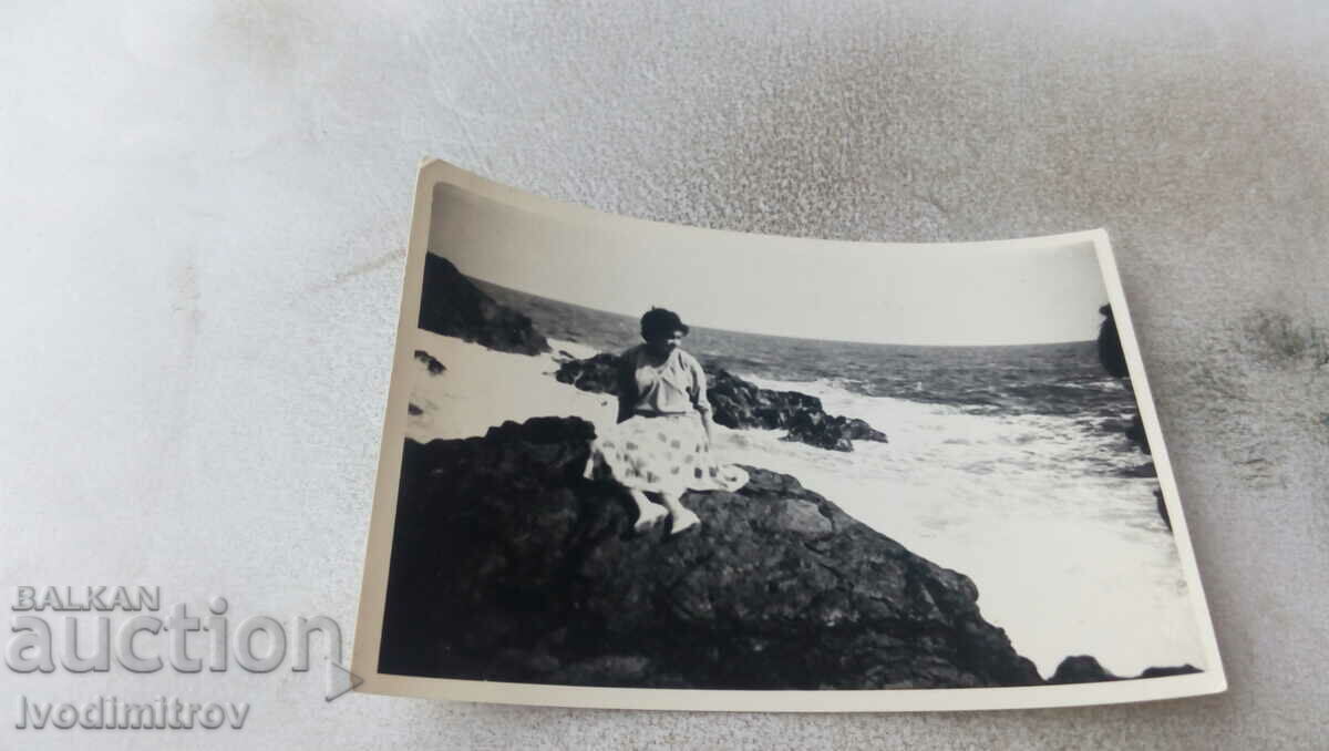 Photo Sozopol Young woman on a rock by the sea