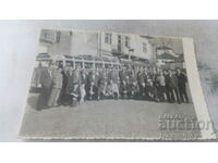 Photo Men in front of retro buses in the square