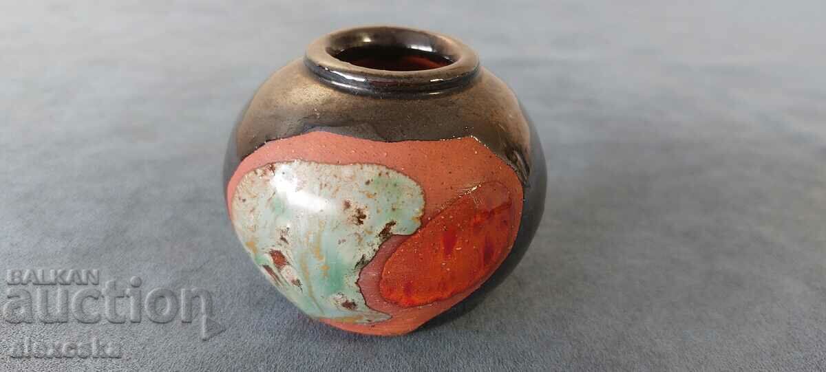 A small ceramic vase