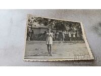 Photo Girl in a white dress in the schoolyard