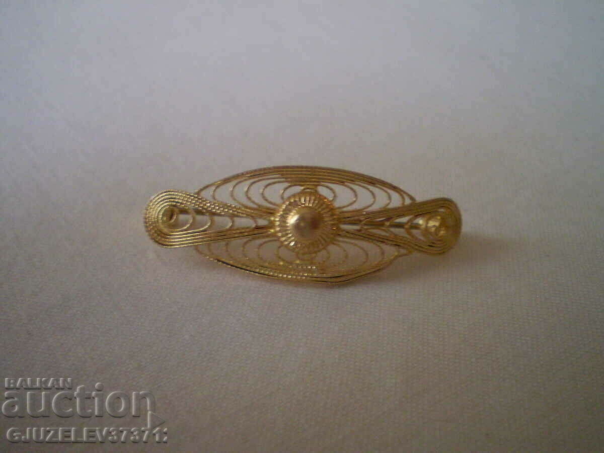 Old brooch with gilding, filigree