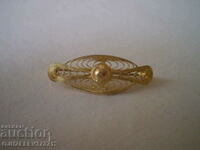 Old brooch with gilding, filigree
