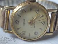 Old ladies gold watch.