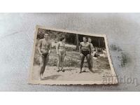 Photo Bankya Three men and a woman in swimsuits on the sand 1951