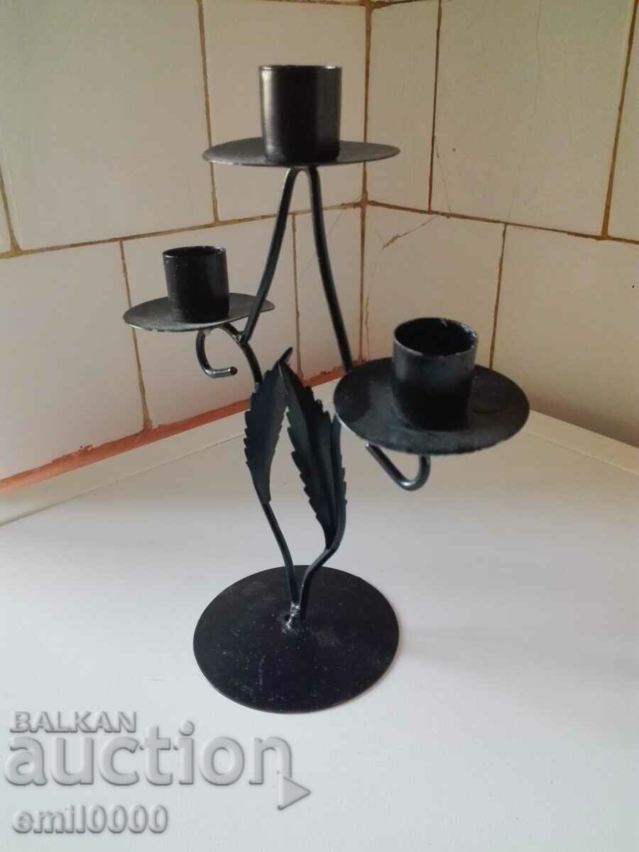 Auction  Metal candlestick trio.