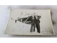 Photo Two sailors at the harbor in front of the steamship Bulgaria