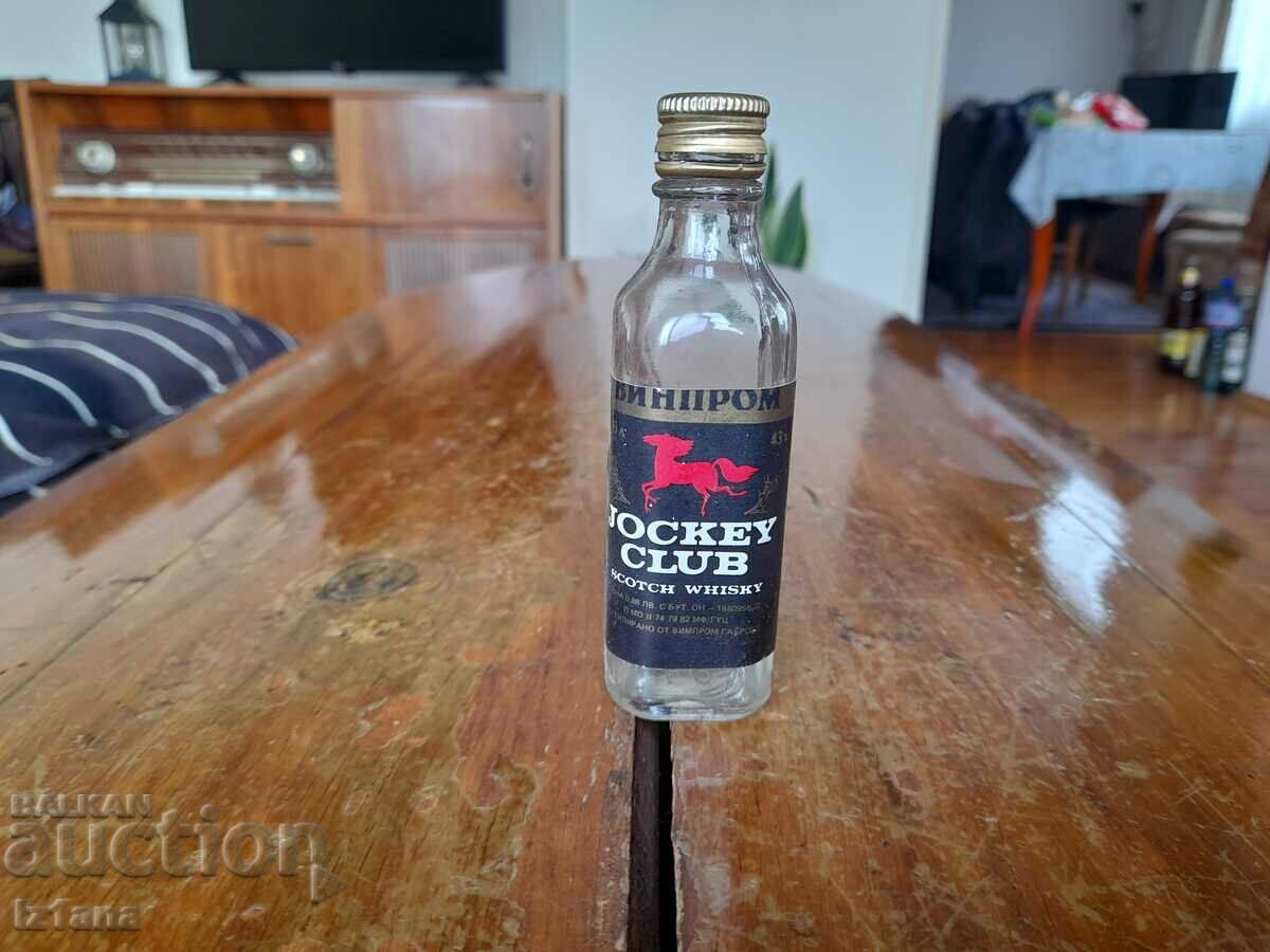 An old Jockey Club whiskey bottle An old Jockey Club whiskey bottle