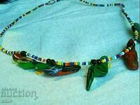 a beautiful necklace of beads and leather parrots