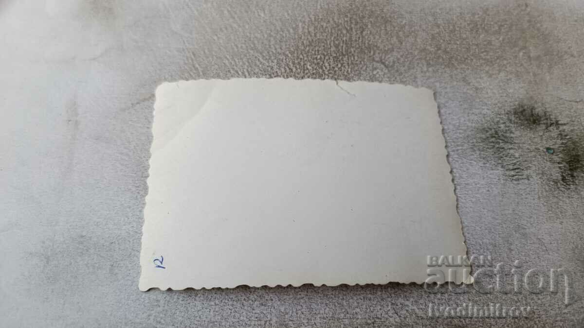 Photo Man and woman in swimsuits on a rock by the sea with price 1.35 BGN | € 0.69